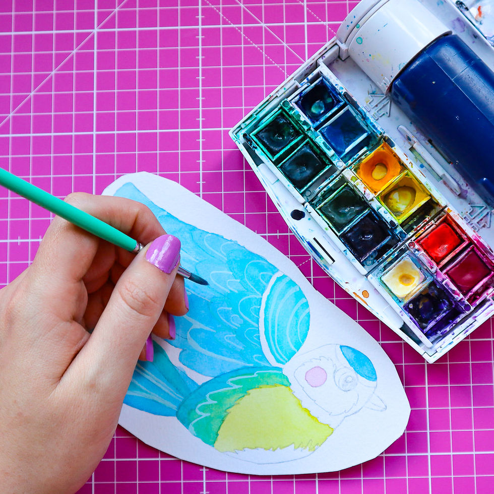 Eco wooden blue tit pin displayed on rustic wood surface, ideal gift for wildlife enthusiasts