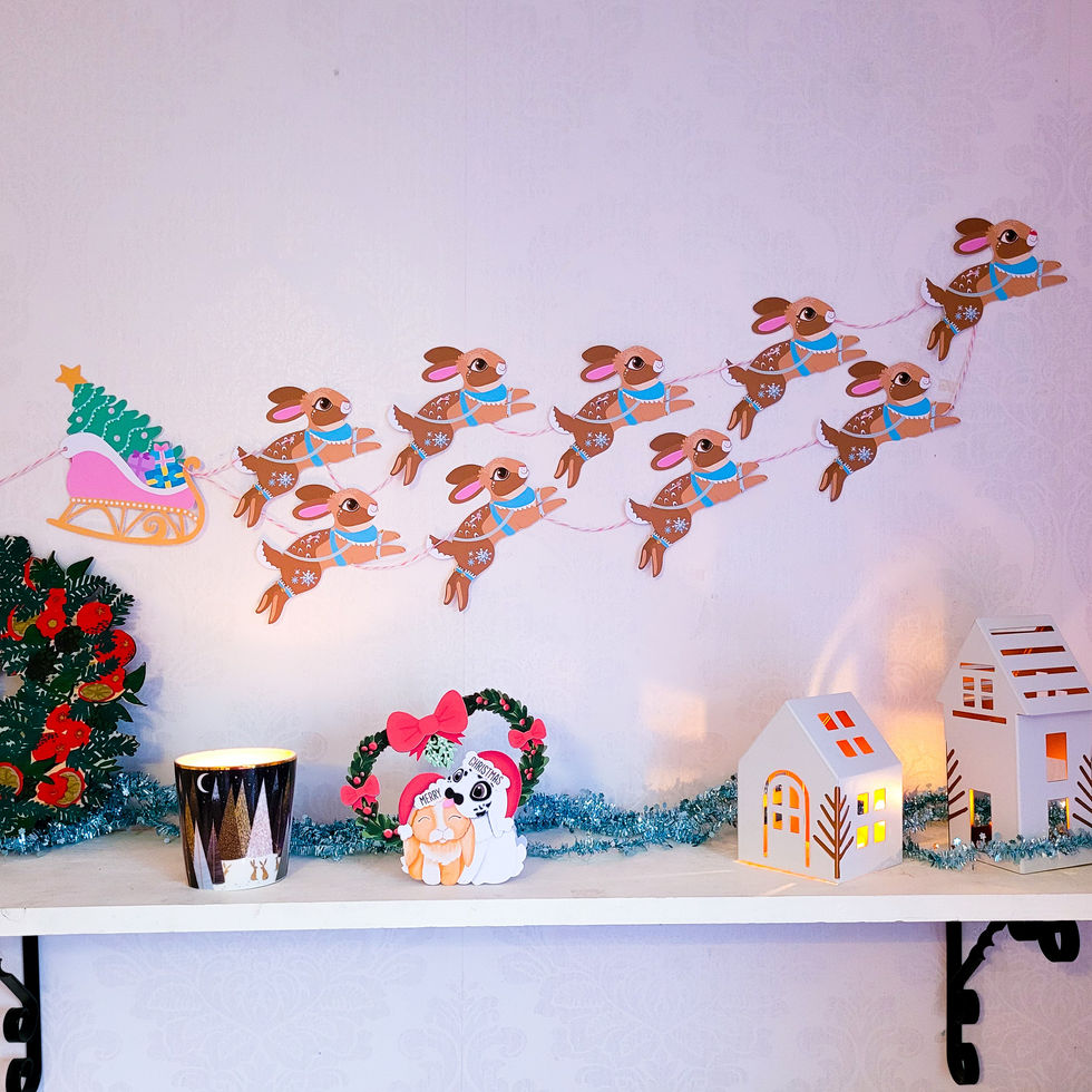 Whimsical paper decoration of rabbits riding a Christmas sleigh