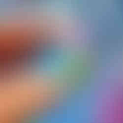 Close-up of blue tit wooden brooch made from sustainable walnut veneered MDF with glossy details