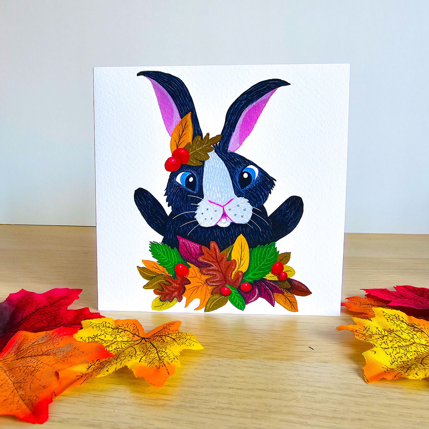 Whimsical autumn rabbit illustration on greeting card