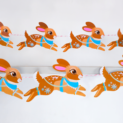 Cozy winter garland featuring cute bunnies and sleigh design