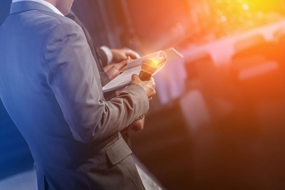 A marriage celebrant in a suit holding a suit