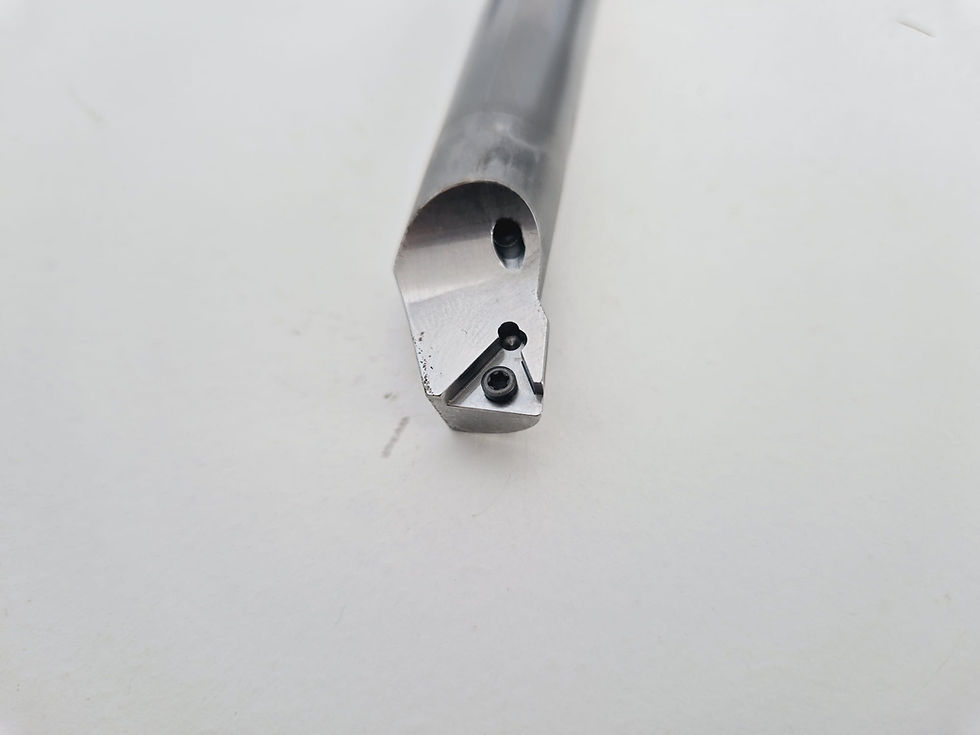 Close-up CNC turning tool on a light background