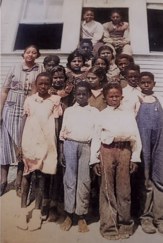 Students who attended the first all-Black free school in Gillespie County in the late 1800s pose in front of the one-room school building where first through sixth grade studied. Francis Phillips is the second student on the second row from the left.