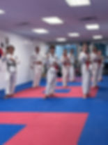 Martial arts class students practice forms