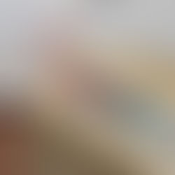 A female smiling while laying in her wicker casket of choice to try it on for size.