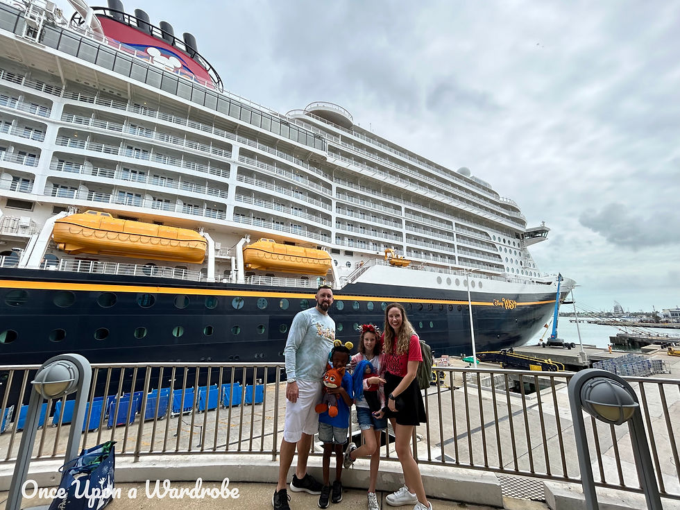 Family in front of the Disney Wish cruise ship