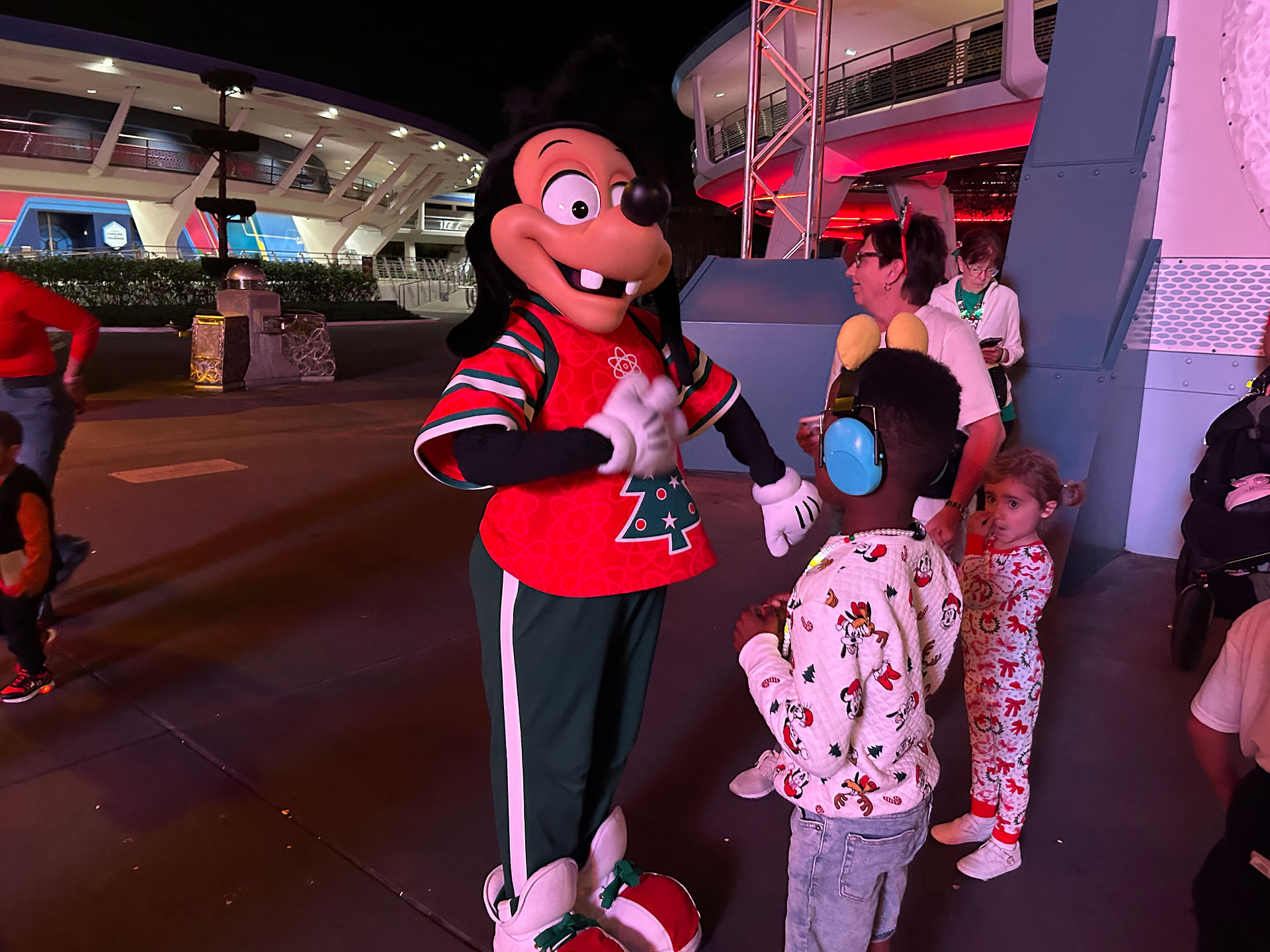 Club Tinsel dance party scene at Mickey’s Very Merry Christmas Party with festive lighting and Max Goof posing in a red holiday sweater.