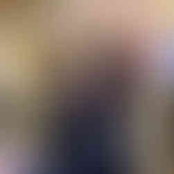 Family dressed in coordinated pirate-themed outfits posing on the grand staircase aboard a Disney Cruise ship during Pirate Night.