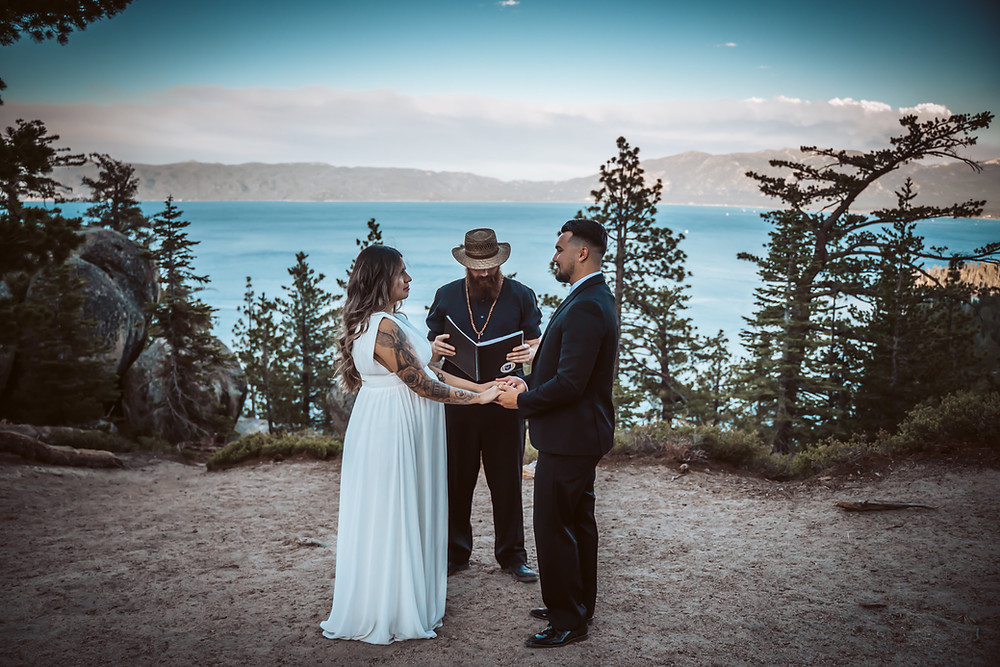A wedding couple standing in front of Lake Tahoe for there elopement ceremony