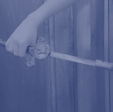 A hand pulling a sword from its sheath.
