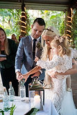 HNs-2oB3.jpeg. This family of three perform a wedding ritual during their ceremony in Tamborine.