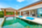 Luxurious villa featuring a stunning green pool and a sunken living room, offering an unforgettable tropical retreat.