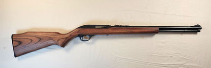 Marlin Model 60 semi-automatic .22 caliber rifle laid on a display table, classic wood stock and blued barrel visible
