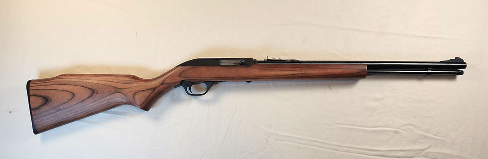Marlin Model 60 semi-automatic .22 caliber rifle laid on a display table, classic wood stock and blued barrel visible