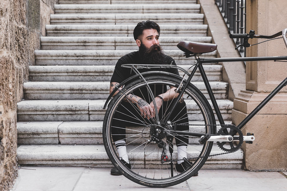 portrait-young-man-sitting-staircase-with-bicycle.jpg
