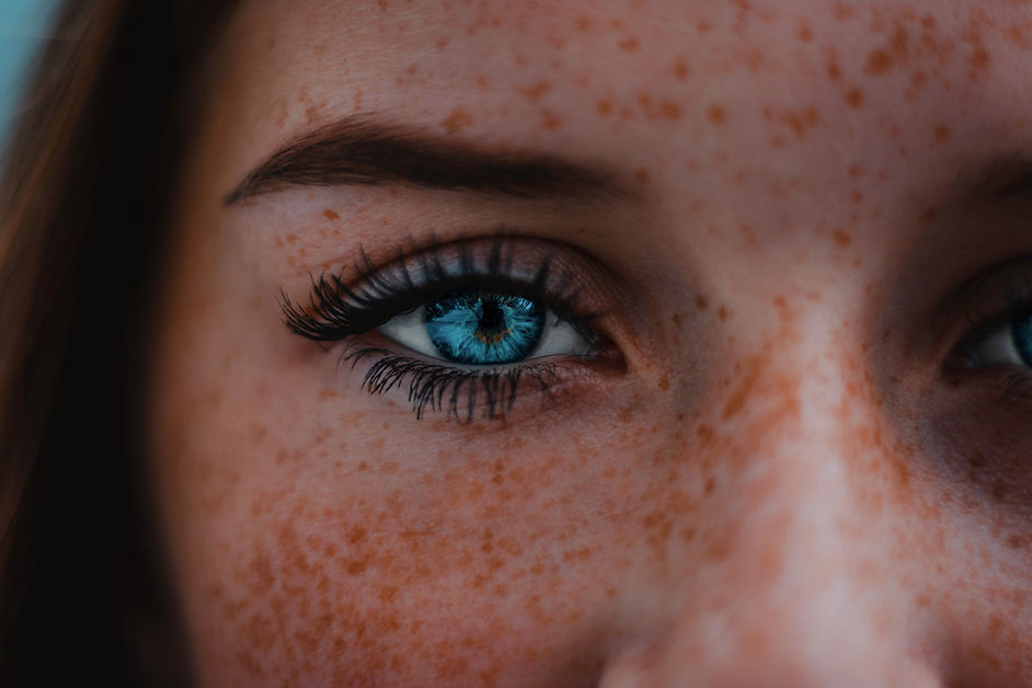 Close-up of a blue eye with long eyelashes, featured on Identity Salon Suites’ homepage in Reno, NV.