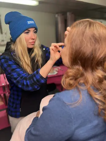 Student practicing eyebrow shaping during hands-on training.