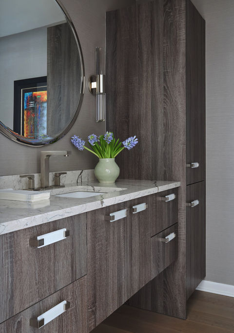 This client was looking for a Deerfield interior designer to create a dramatic and understated powder room. A. Klein Interior Design chose cabinetry and finishes that create the moody and comfortable bathroom space desired.