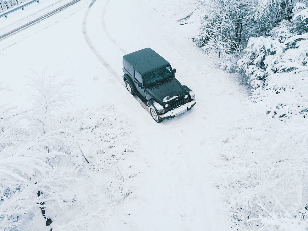 a Jeep Wrangler going off-road in the snow