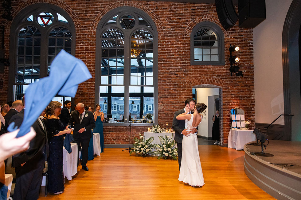 couple kissing at their wedding reception