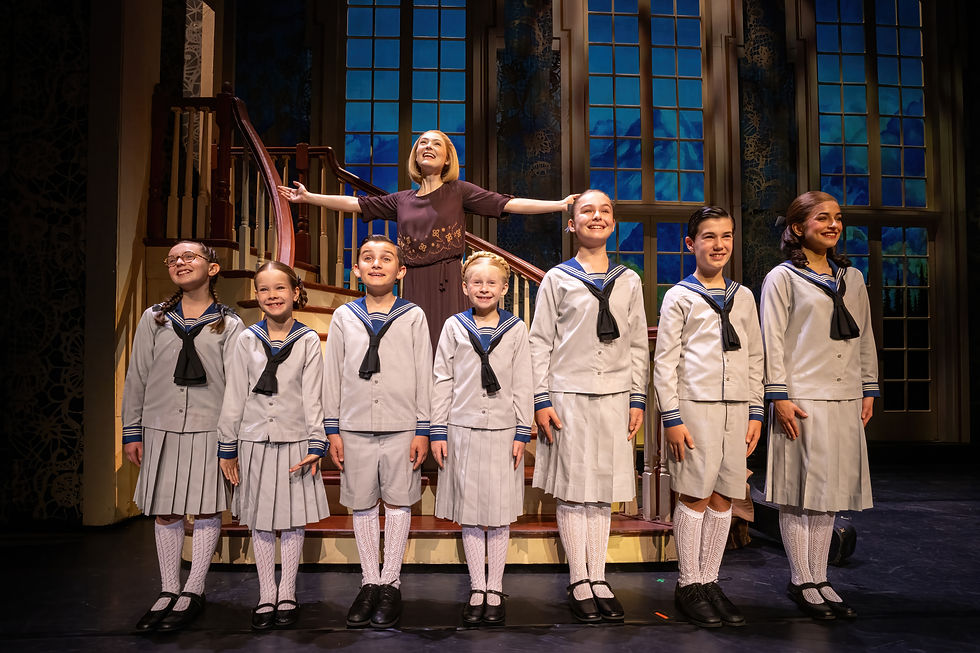Natalie Duncan (Maria), Julia Salatti (Liesl), and the von Trapp children in The Sound of