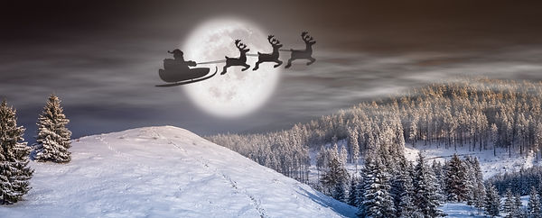 Santa's sleigh flies over snowy landscape