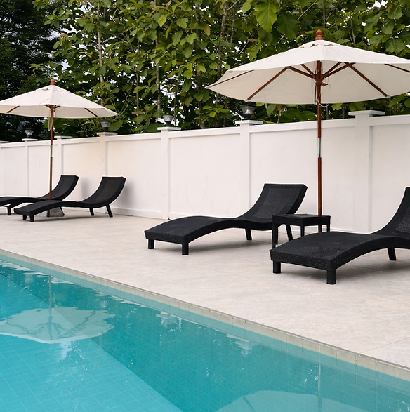 Serene poolside retreat on a sunny day.png