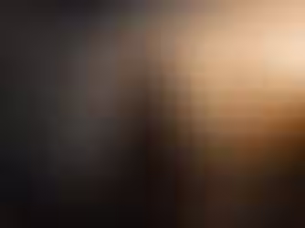 Woman sitting quietly on a mountainside overlooking a lake at sunset with an open Bible and coffee beside her. On one side of the image, notifications, social media, news, distractions, fear, pressure, and busyness rush past in a blur, while the Scripture "Be still, and know that I am God. – Psalm 46:10" appears in the peaceful sky, illustrating the contrast between life's distractions and finding quiet time with God.