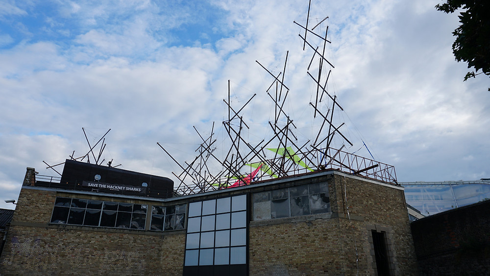 A photograph of an abstract sculpture by Antepavilion on the roof of an art studio outdoors