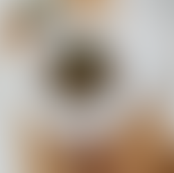 Assiette creuse blanche avec des lentilles aux champignons sur une planche en bois avec quelques tas de lentilles blondes et quelques tas de clous de girofle