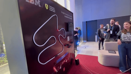 Autorama LED Phygital com traçado iluminado, controles 3D e pista personalizada. Participantes configuram clima e horário da corrida antes da largada.
