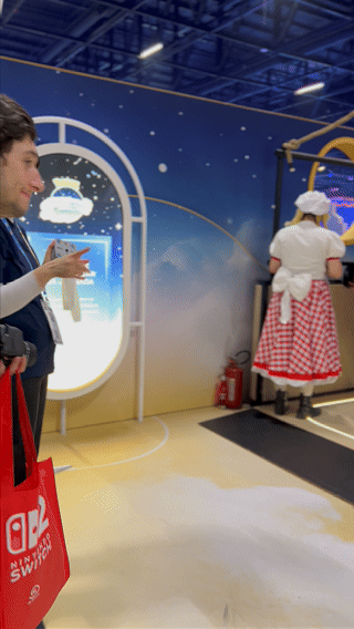 Visitantes interagem na ativação Pokémon Company | BGS 2025 – Experiência Megaevolução. Totens digitais da Phygital Solutions exibem o processo de escolha do Pokémon e da Mega Evolução, com público participando, cartões personalizados e iluminação temática do estande.