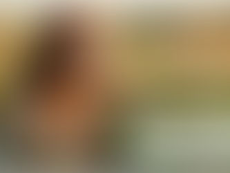 a woman smelling flowers in a field