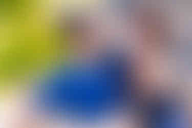 bride in black and a tiara hugging groom