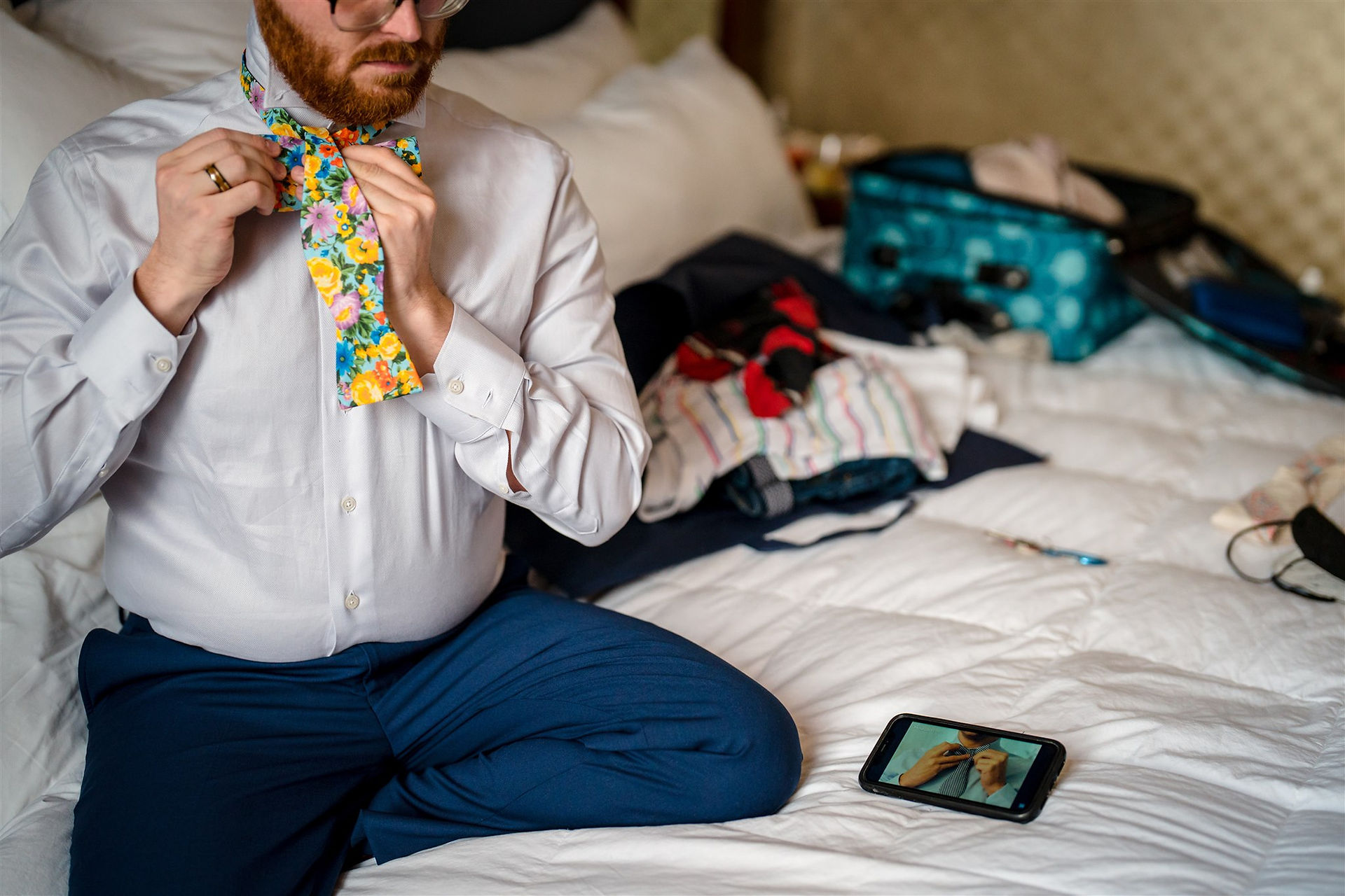 groom watching youtube to figure out how to tie a tie.
