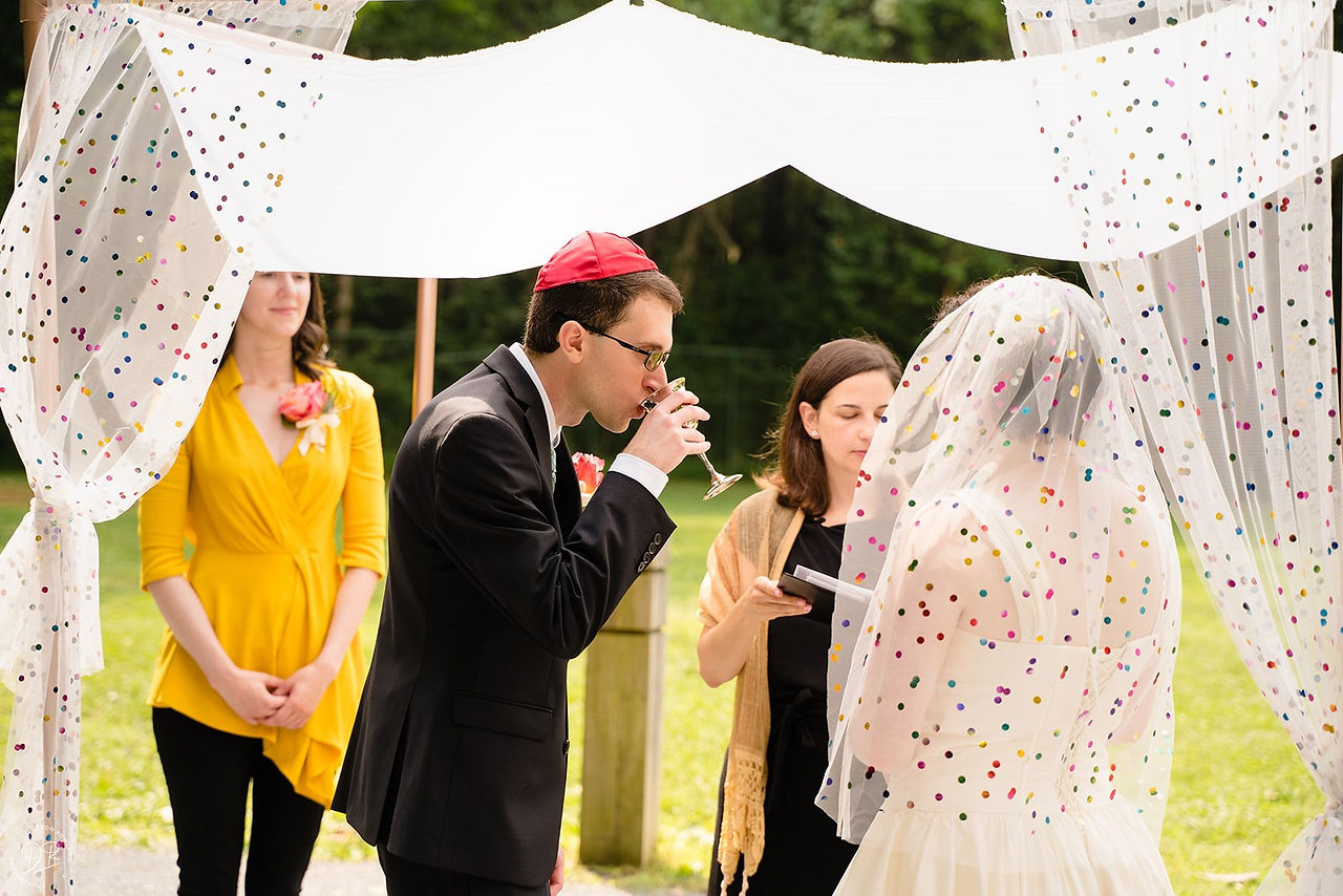 groom drinking from wine glass