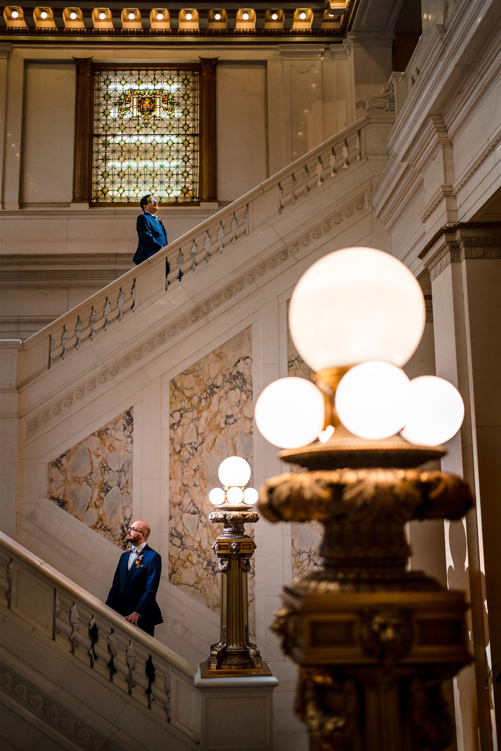 grooms on marble stairs