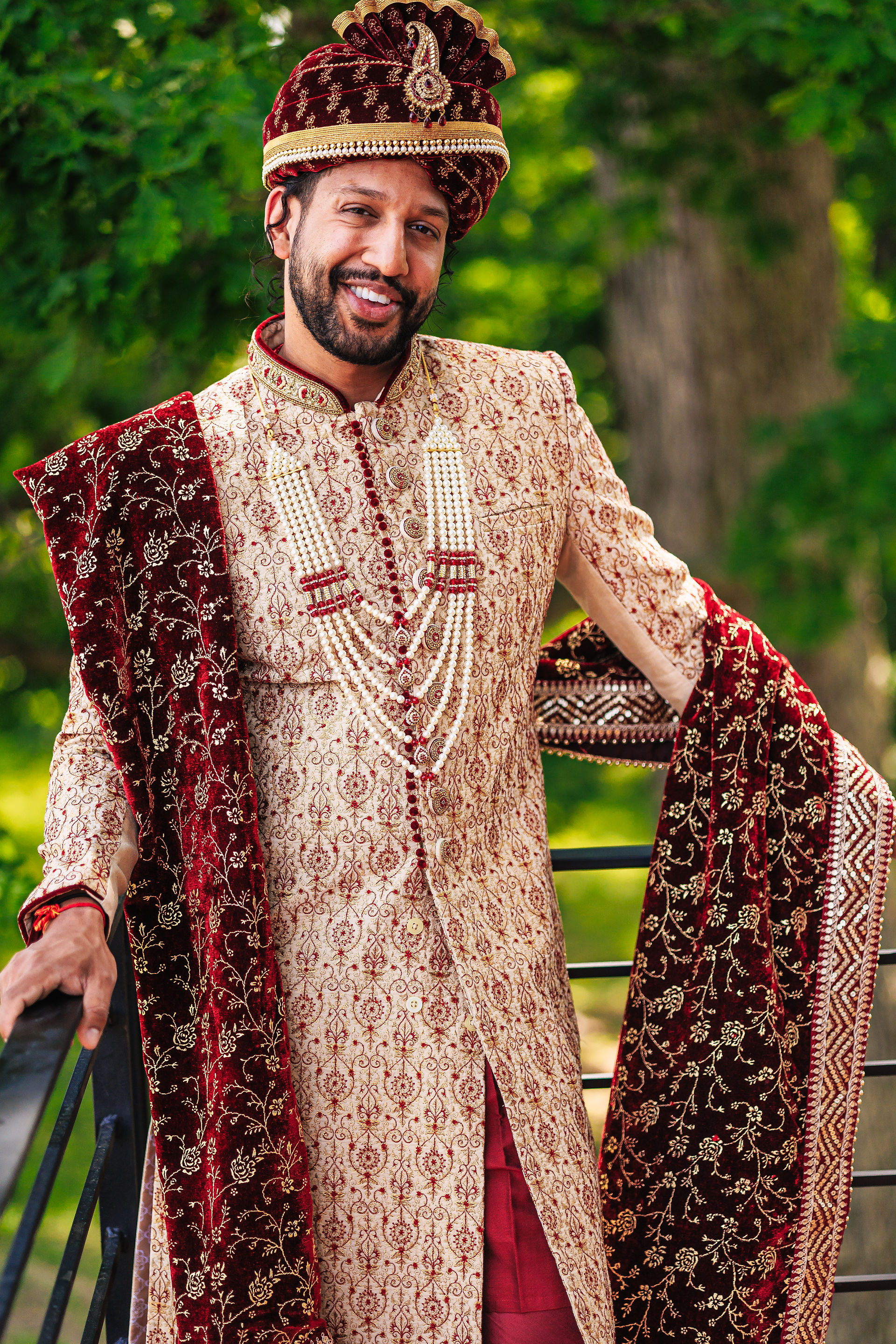 groom in red and gold Sherwani and outfit
