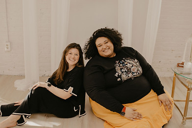 image of two women sitting together on the floor