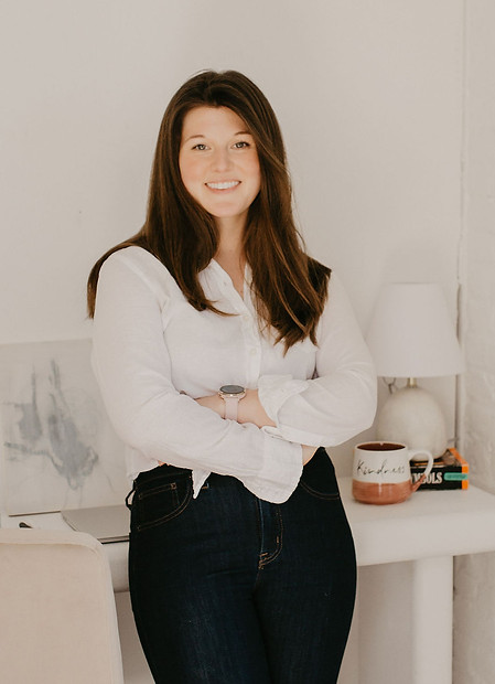 image of woman standing against desk
