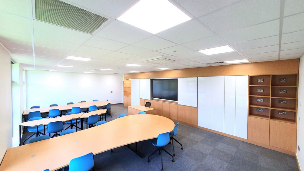 Bespoke ICT suite design with curved workspace and integrated storage solutions