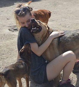women cuddling dog