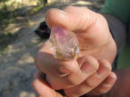 Image of an hand holding a crystal