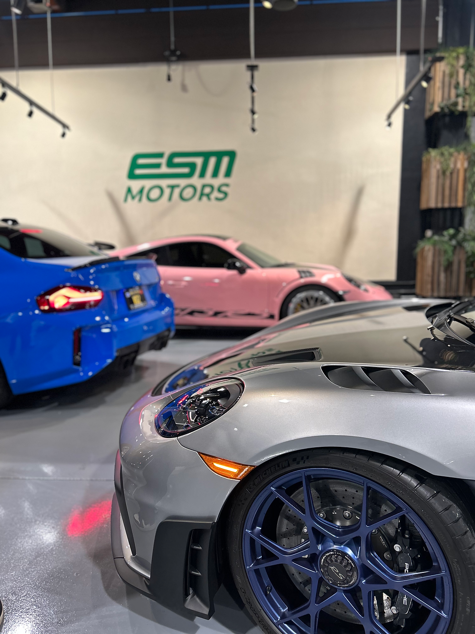 Luxury vehicles inside the ESM Motors XPEL protection studio in San Francisco.