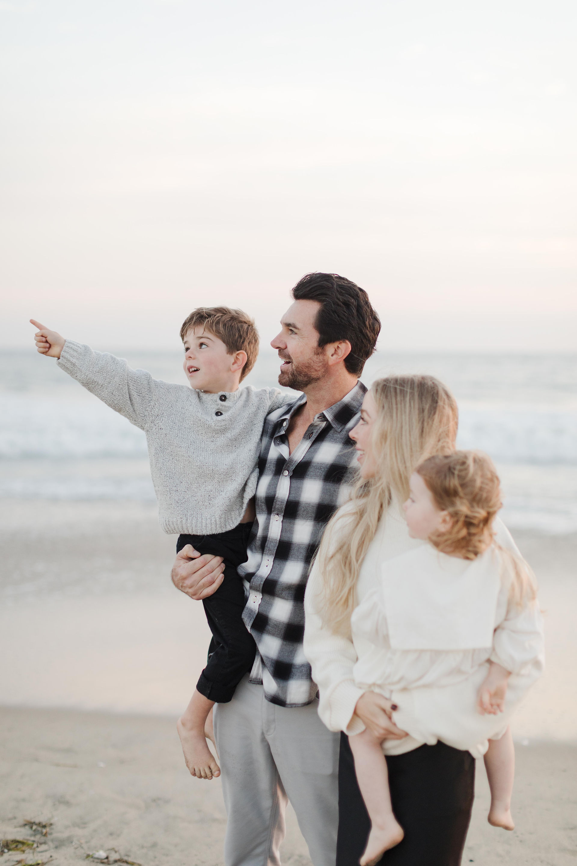 Family standing together with waves in the background at Newport Beach