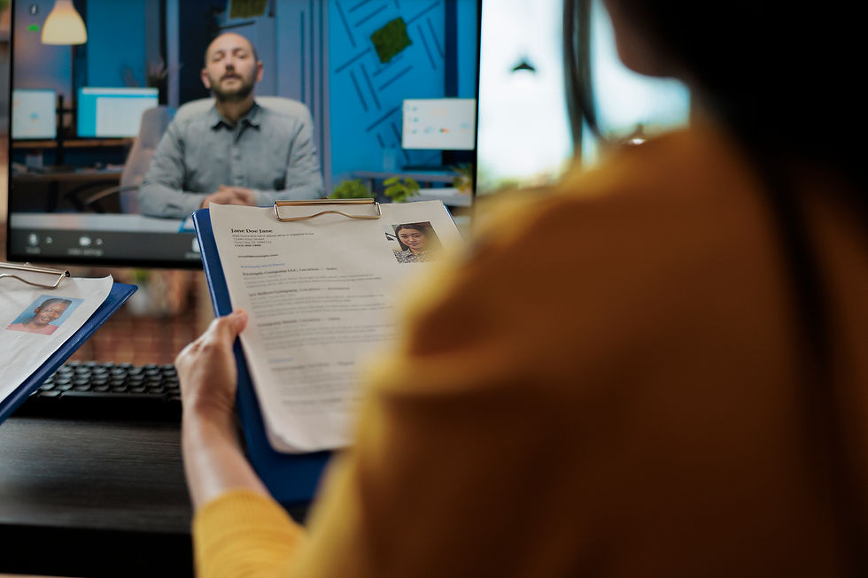 HR manager reviewing freelancer resumes during a virtual job interview via video call in a modern office setting.