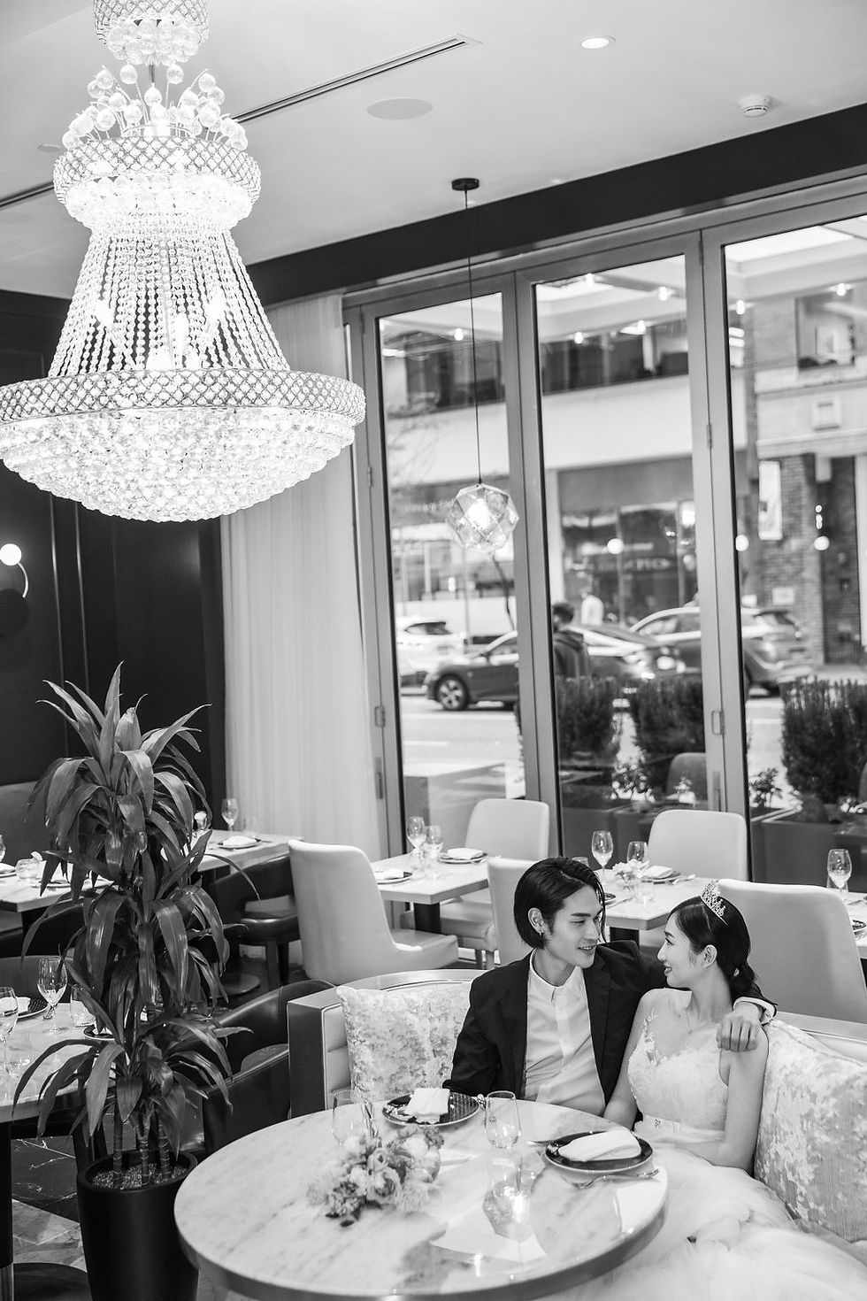 In this captivating image, a loving couple stands against the elegant backdrop of Azur Hotel, their special day artfully frozen in time by our skilled Vancouver wedding photographer, showcasing a perfect blend of romance and expertise in every frame