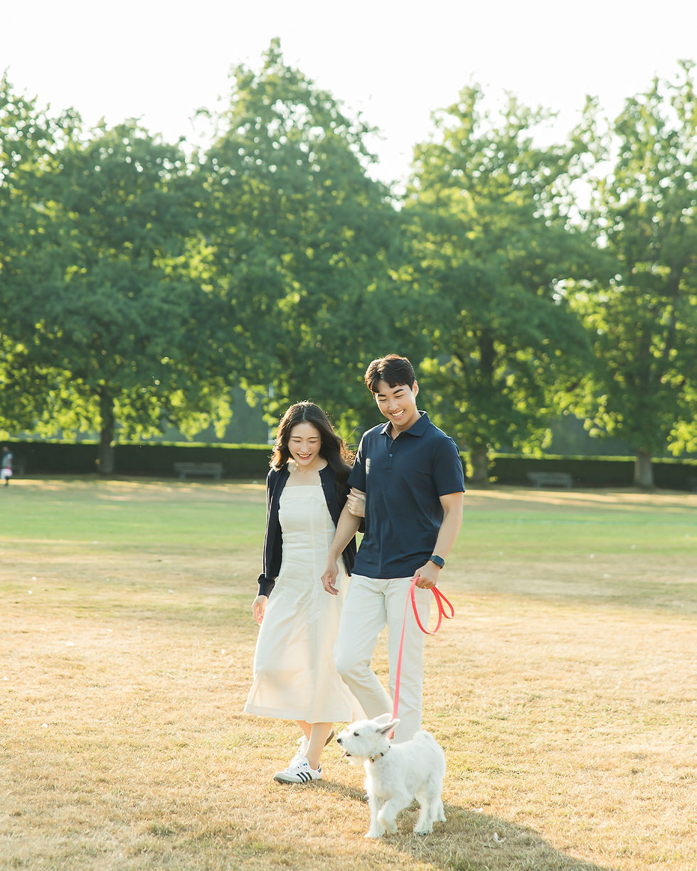 Engagement photos Vancouver couple walking with dog at Stanley Park during golden hour