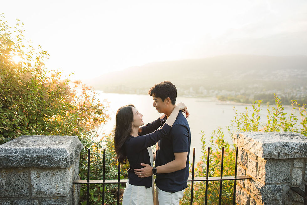 Engagement photos Vancouver Stanley Park couple smiling in natural sunset light